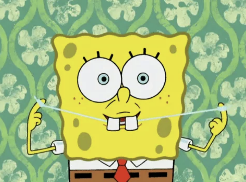 SpongeBob SquarePants, a cartoon character, flosses his teeth in front of a patterned wall