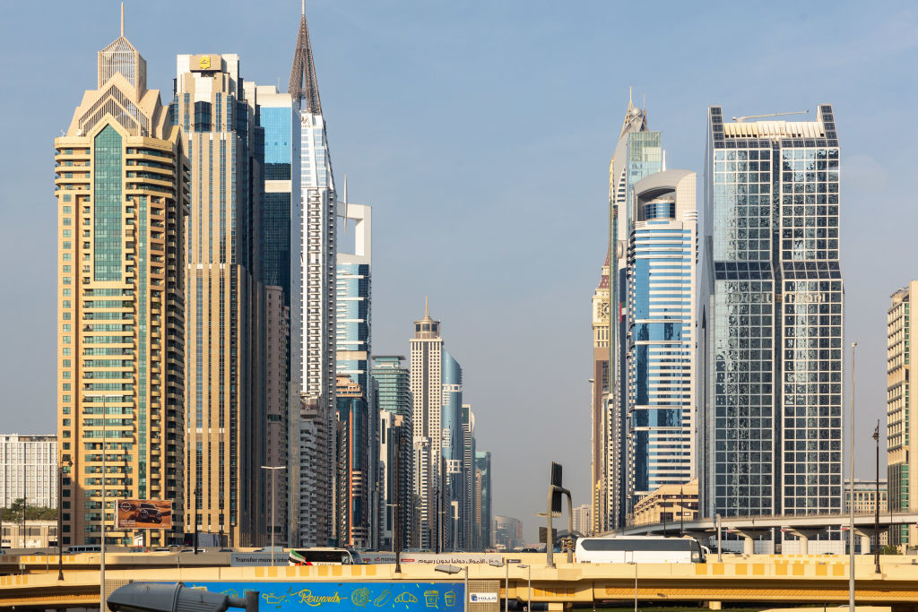 A cityscape view of Dubai&#x27;s modern skyline featuring numerous high-rise buildings with varied architectural designs