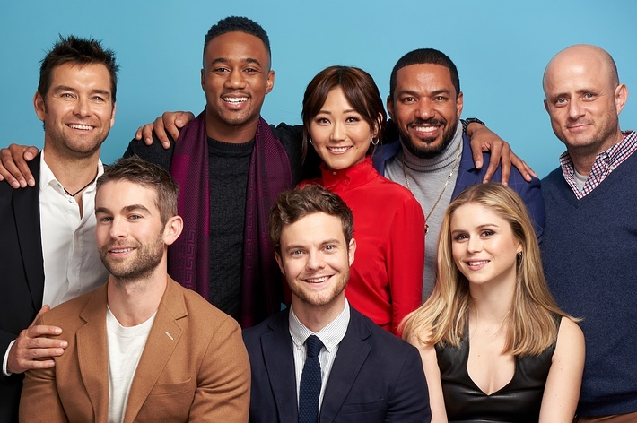 Group photo of Jack Quaid, Jessie T. Usher, Karen Fukuhara, Laz Alonso, Karl Urban, Tomer Capon, Antony Starr, and Erin Moriarty smiling in casual clothes