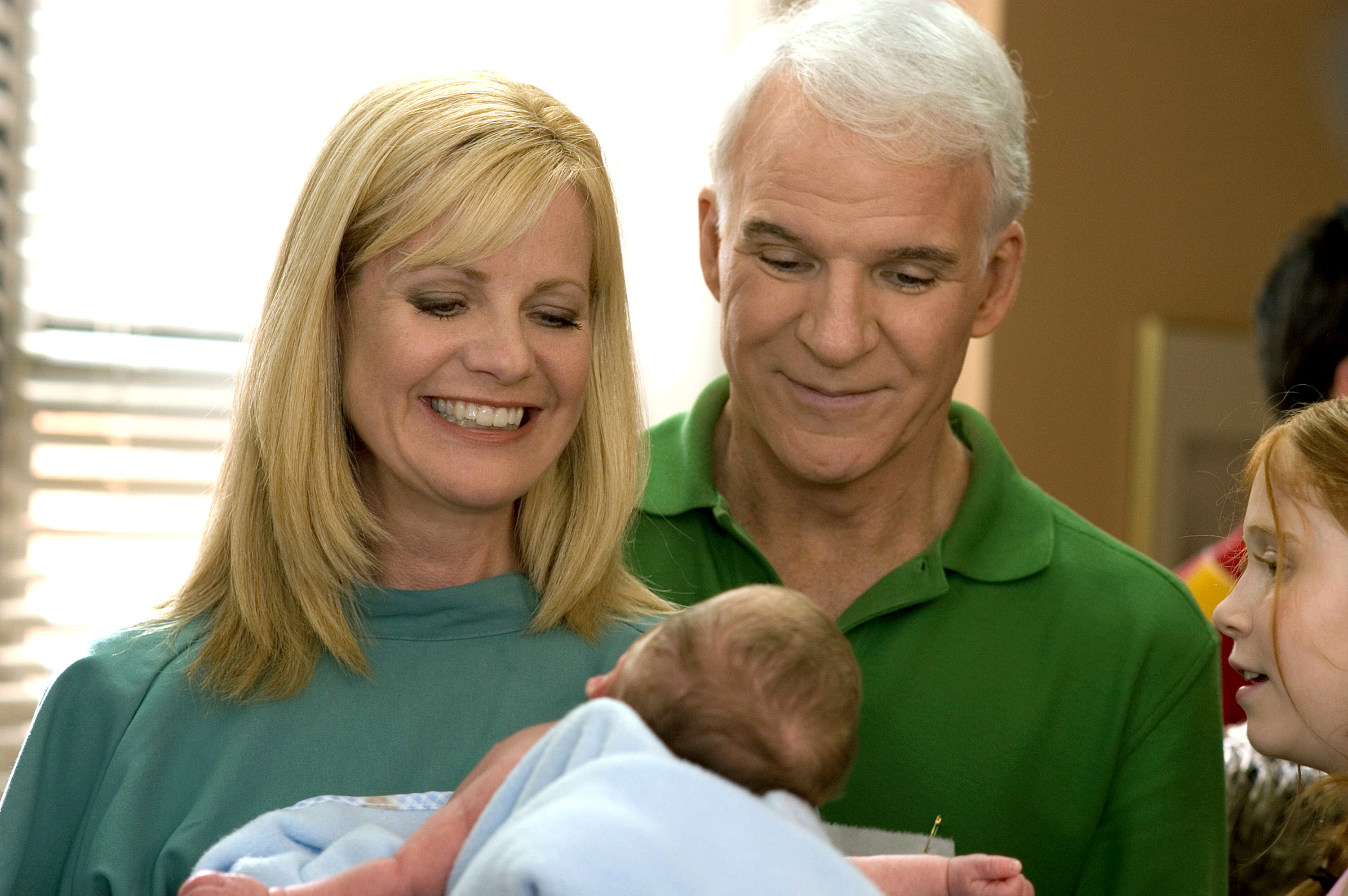 Bonnie Hunt and Steve Martin looking at a newborn baby in their arms