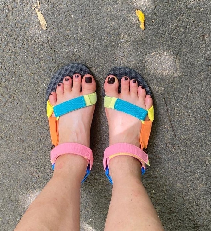 reviewer in multicolored strappy teva sandals