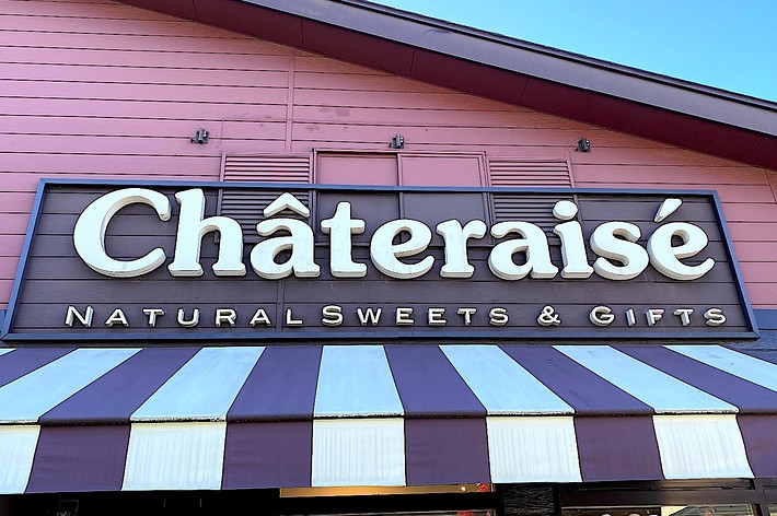 Front view of Châteraisé storefront with a striped awning. Sign reads: “Châteraisé Natural Sweets & Gifts."