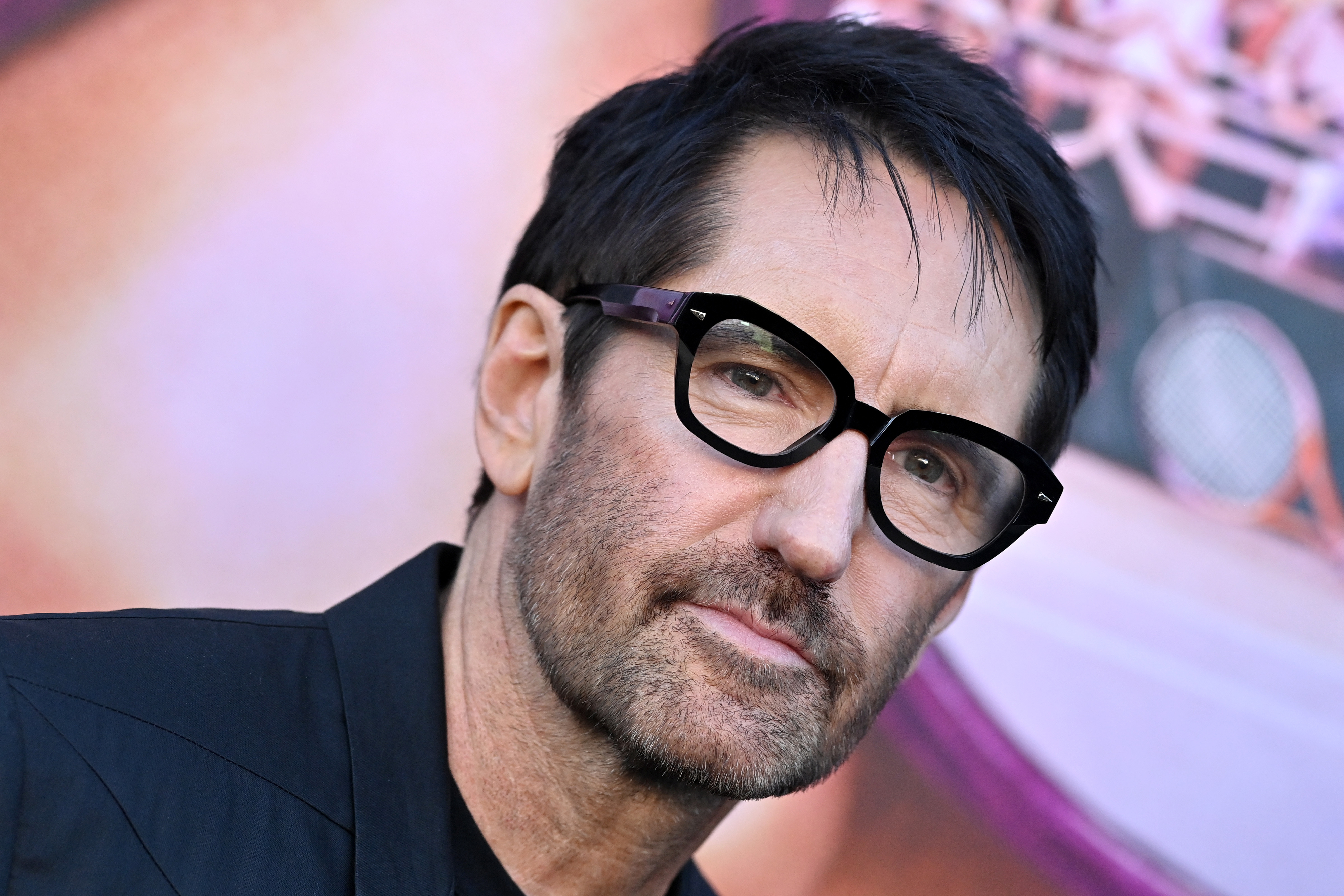 Trent Reznor at a public event wearing thick-framed glasses and a black outfit