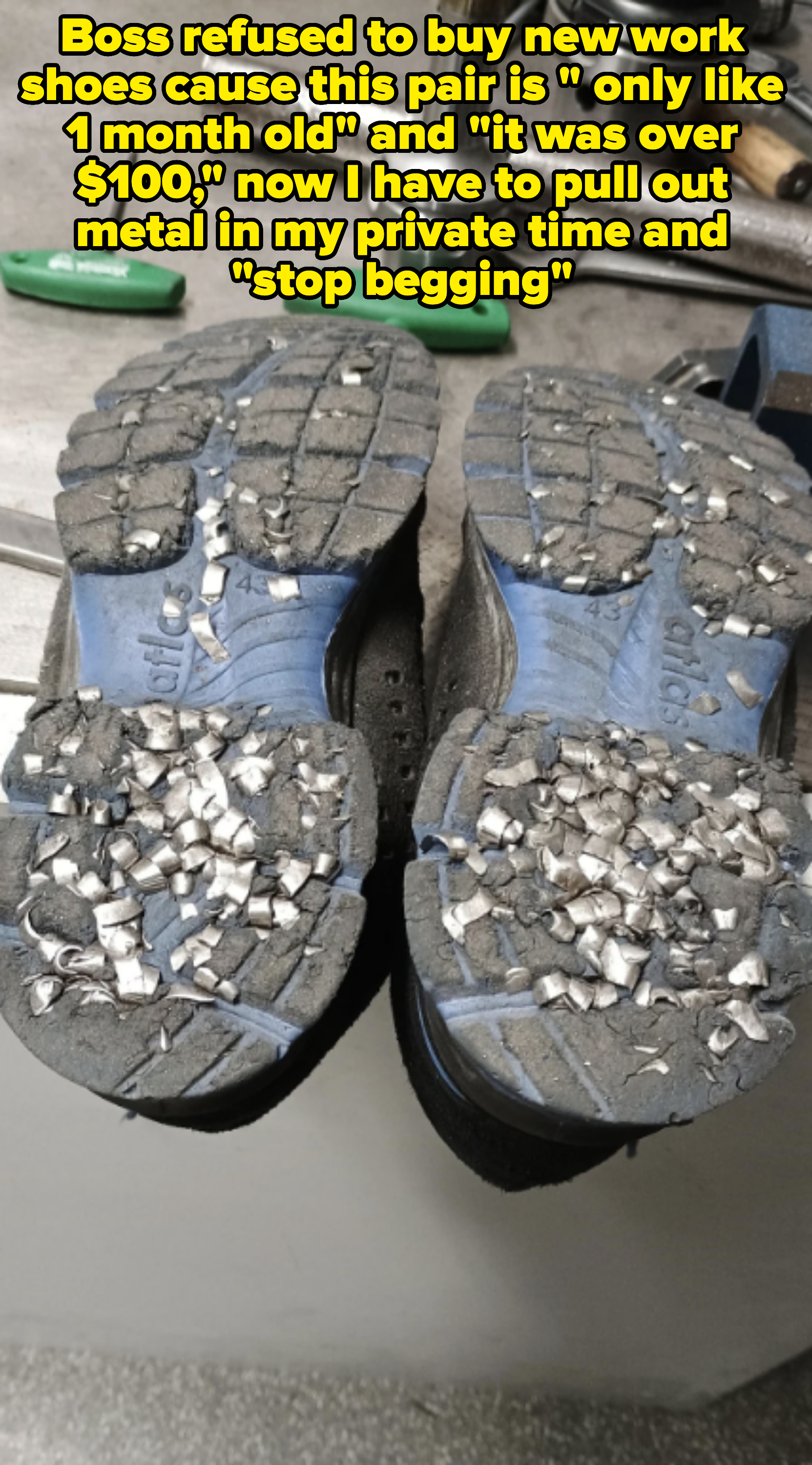 Worn-out sneaker soles covered with metal shavings on a workbench with tools