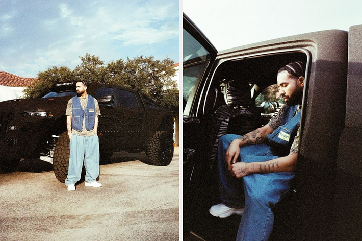 Drake poses outdoors in baggy jeans, white sneakers, and a blue vest with tattoos visible on his arms, leaning against and sitting inside a truck