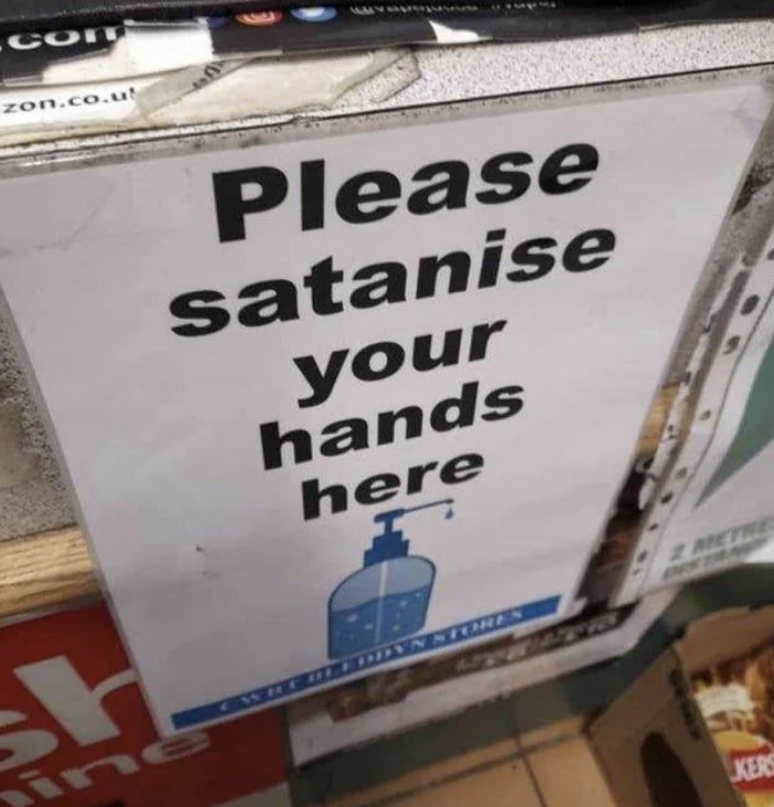 Sign with drawing of a sanitizer bottle reads, "Please satanise your hands here," likely a typo for "sanitize."