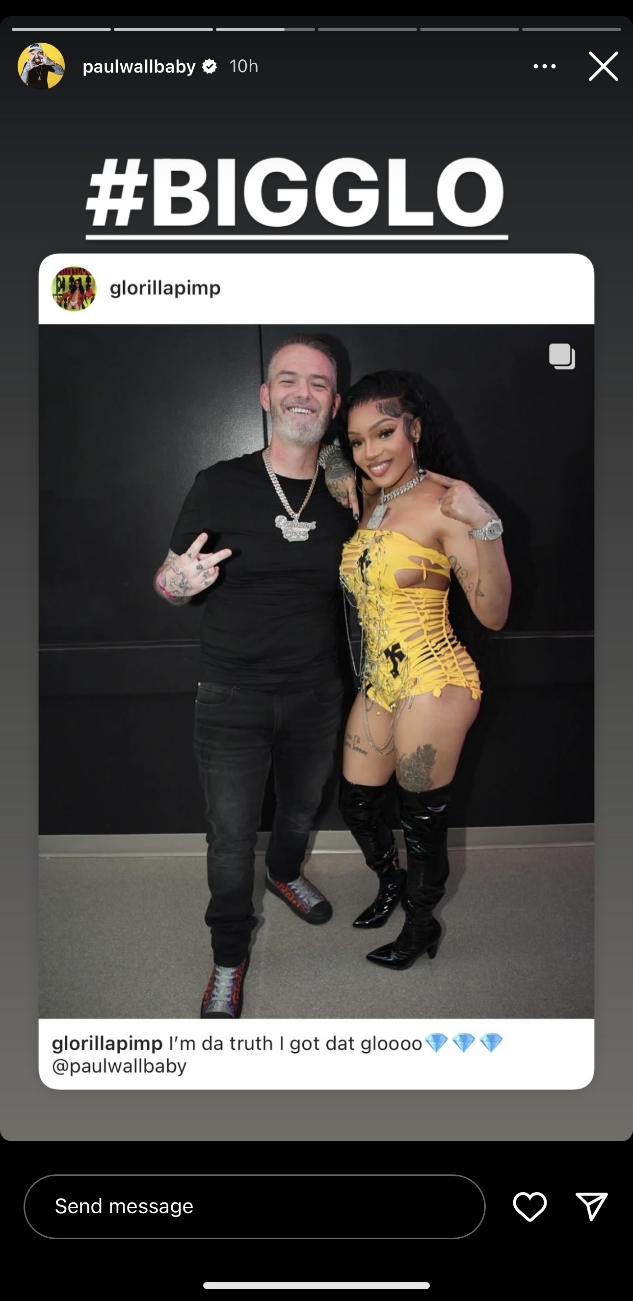 Paul Wall and GloRilla posing together. Paul Wall wears a black t-shirt and jeans, and GloRilla wears a yellow corset dress and thigh-high black boots