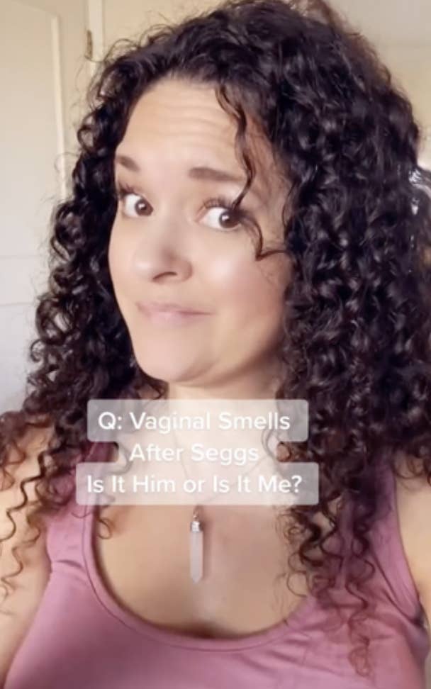 A person with curly hair wearing a tank top is seen with a caption reading, &quot;Q: Vaginal Smells After Seggs Is It Him or Is It Me?&quot;