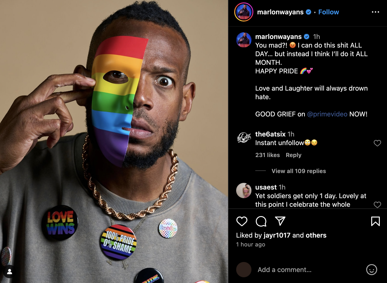 Marlon Wayans holds a rainbow-colored half-mask over his face. He wears a necklace and buttons that display messages supporting LGBTQ+ pride