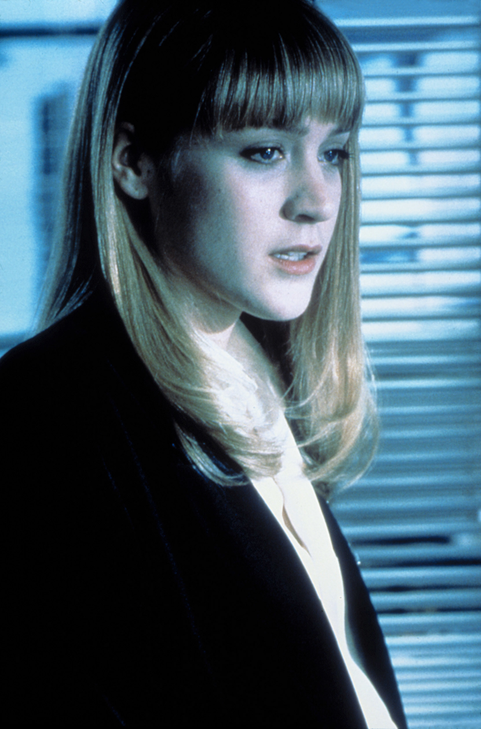 Chloë Sevigny wearing a blouse and blazer, looking thoughtful, in a scene from the movie "Boys Don't Cry."