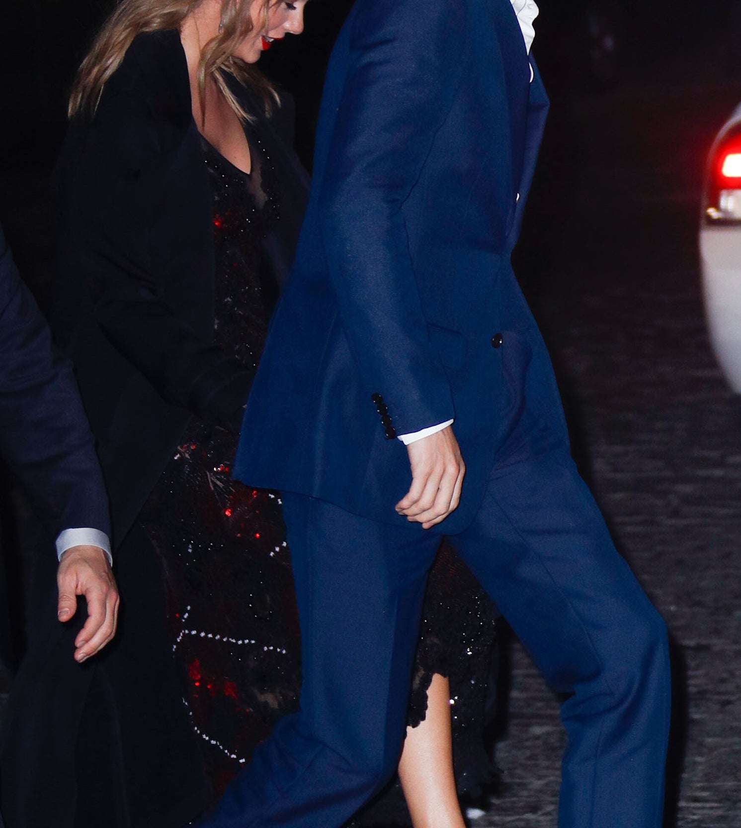 Taylor Swift and Joe Alwyn walk with a security guard