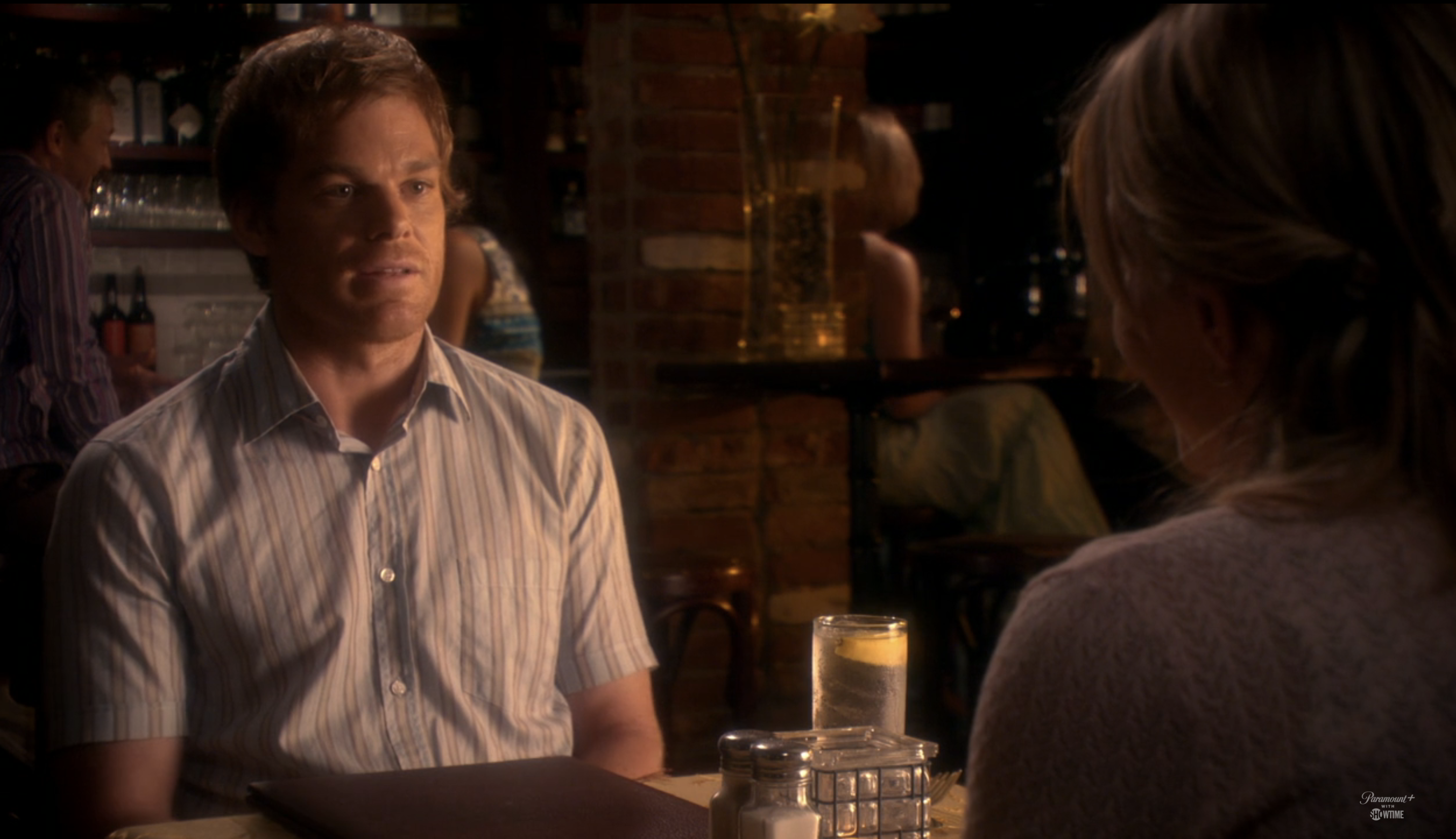 Michael C. Hall as Dexter is talking to Julie Benz's character Rita at a restaurant table in a scene from the TV show &quot;Dexter&quot;