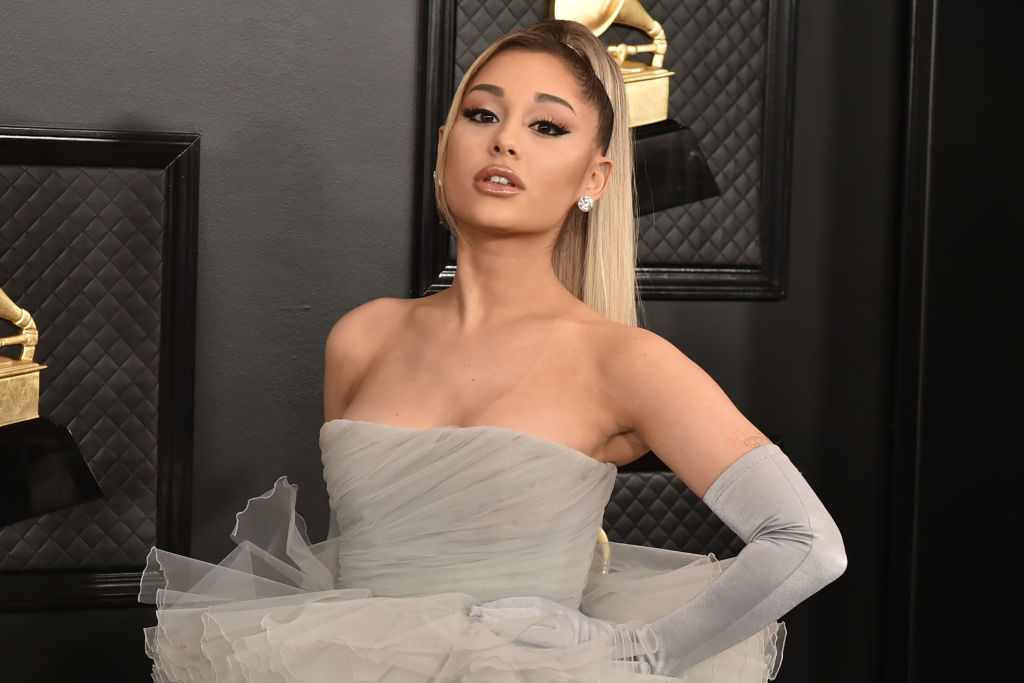 Ariana Grande on the red carpet, wearing a strapless tulle gown and long gloves at the Grammy Awards