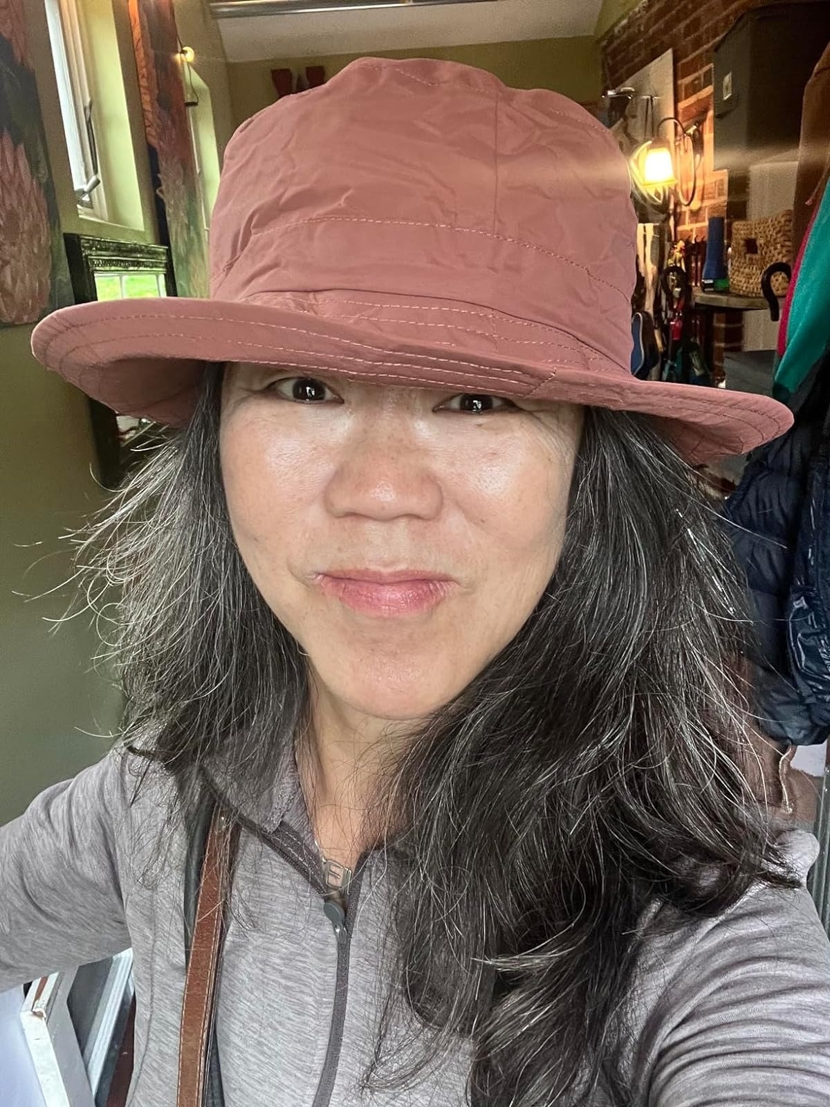 A reviewer wearing a packable sun hat