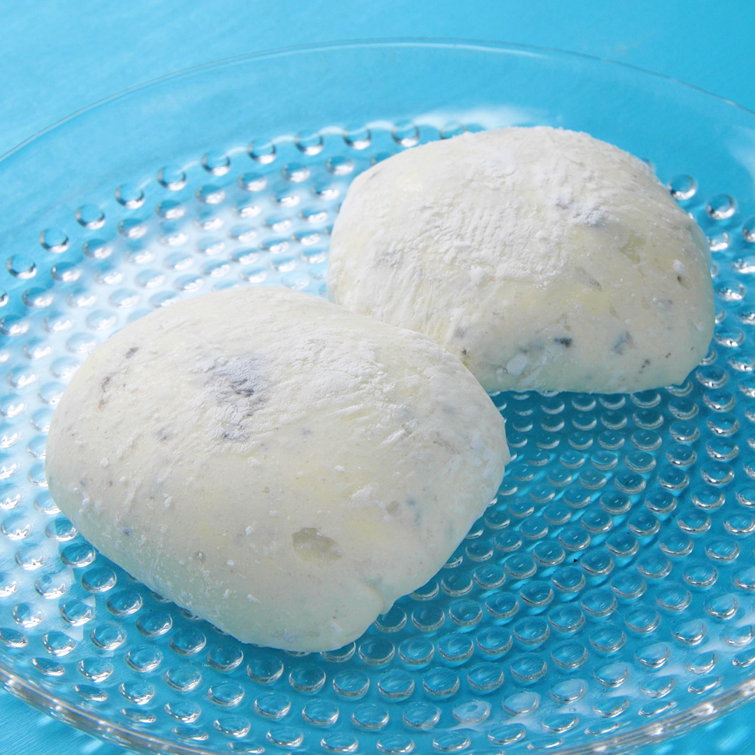 透明な皿に白くて丸い二つのもちのようなお菓子がのっています。