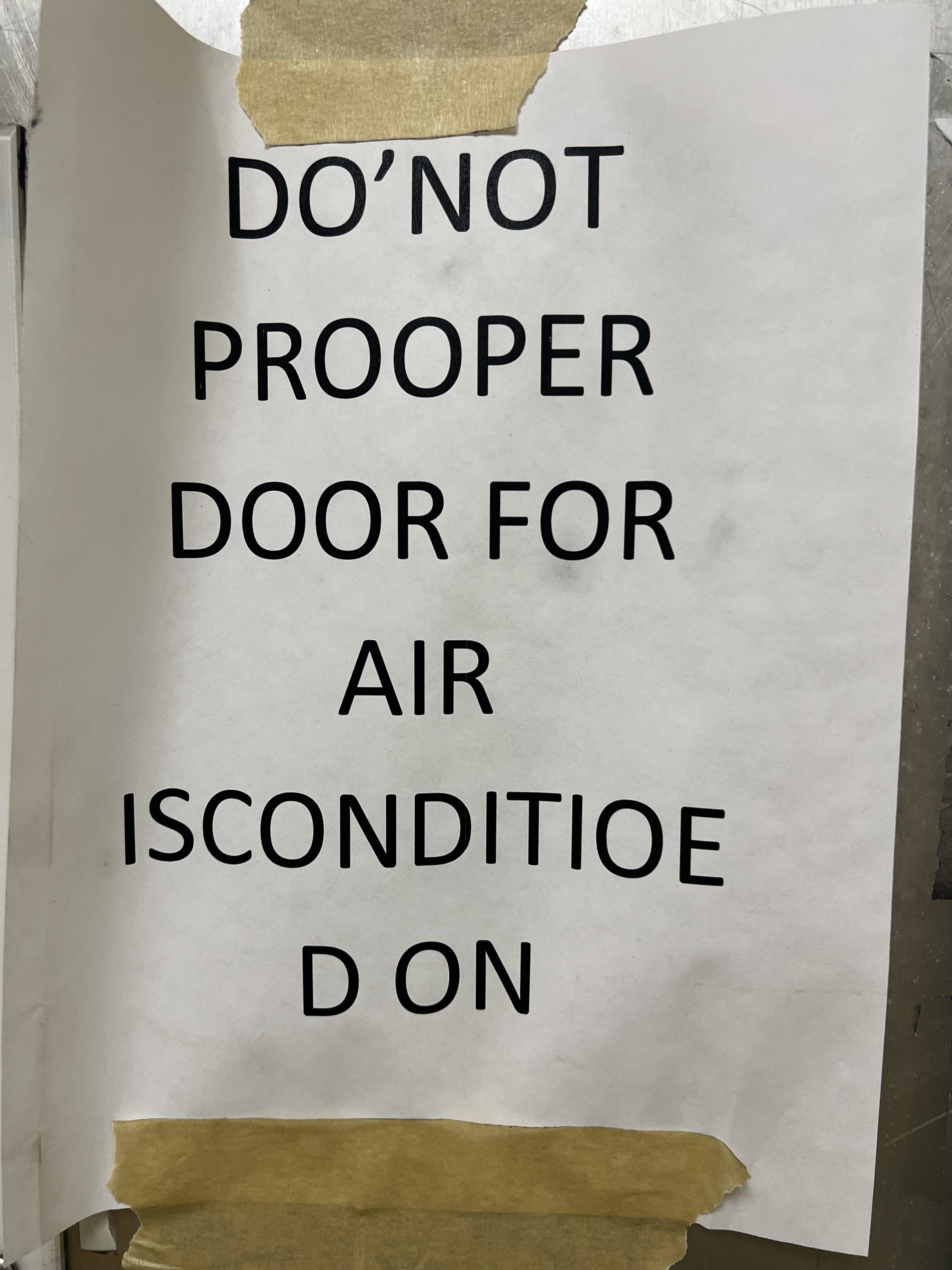 Sign reads: "Do not prooper door for air isconditioe d on."