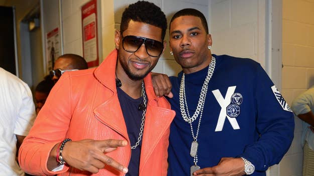 Usher and Nelly pose together, Usher wearing a stylish jacket and sunglasses, Nelly in a casual sweatshirt and chain necklace