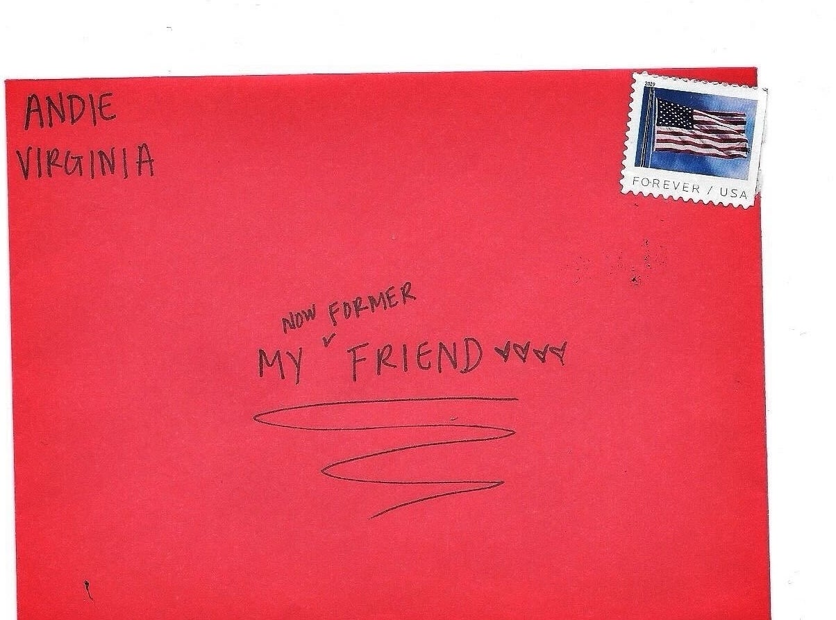 A red envelope addressed to Andie in Virginia with handwritten text, &quot;Now forever my friend&quot; and a postage stamp