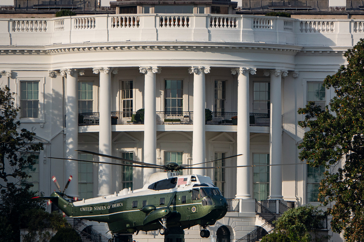 A helicopter labeled "United States of America" is stationed in front of the White House