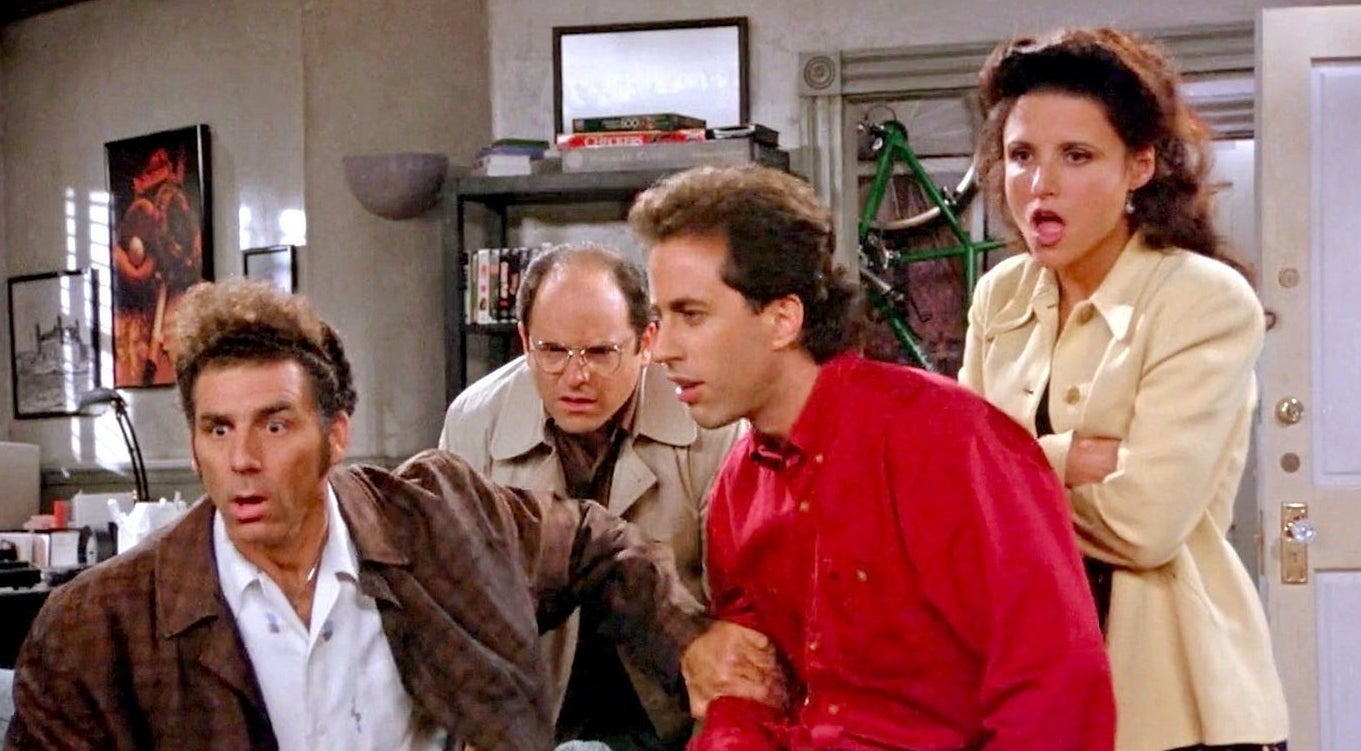 Michael Richards, Jason Alexander, Jerry Seinfeld, and Julia Louis-Dreyfus in a scene from "Seinfeld," with all characters looking surprised or shocked