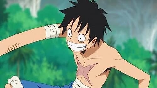 Monkey D. Luffy from One Piece is smiling widely, with a bandaged chest and arms, against a jungle backdrop