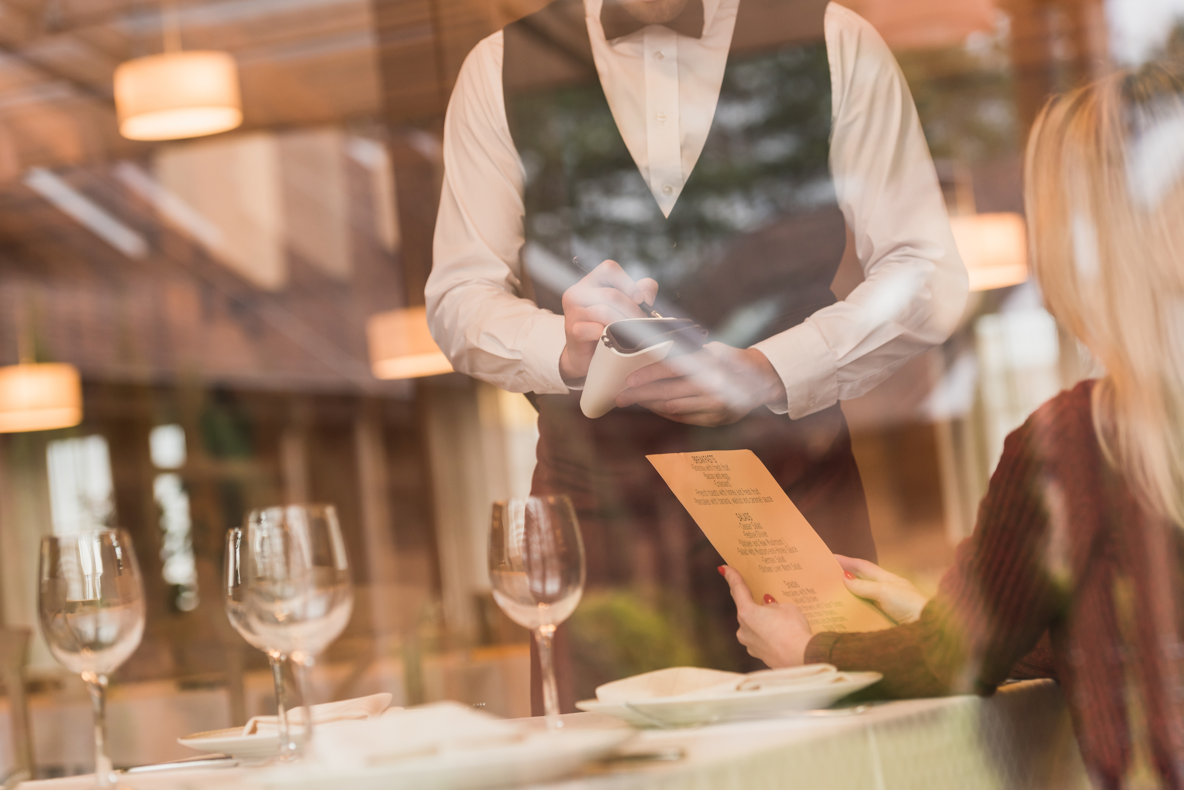 Waiter taking an order at an upscale restaurant