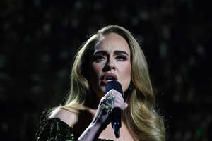 Adele sings passionately into a microphone