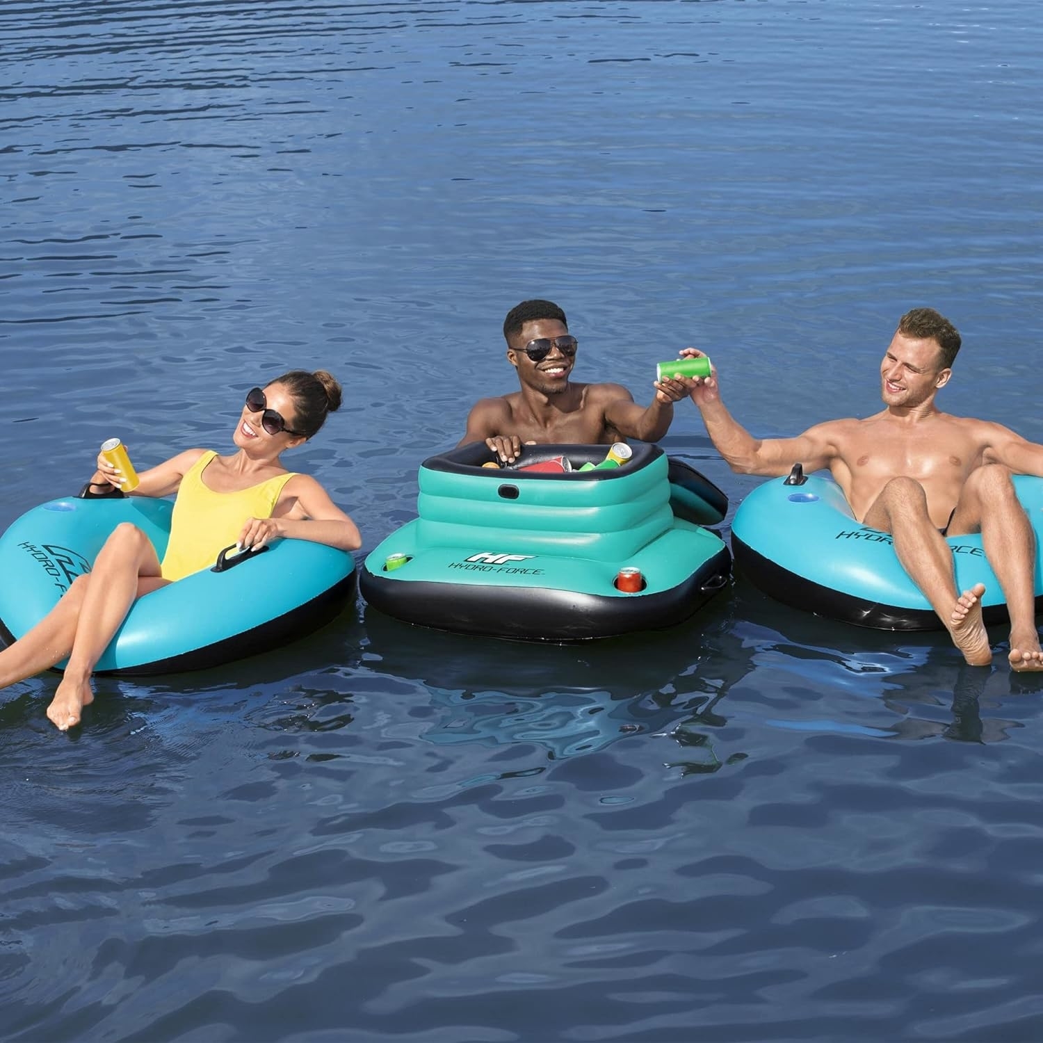 People enjoying the sun while floating on inflatable rafts in a lake