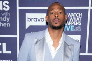 Marlon Wayans at the "Watch What Happens Live with Andy Cohen" event, wearing a light-colored, three-piece suit with a satin lapel