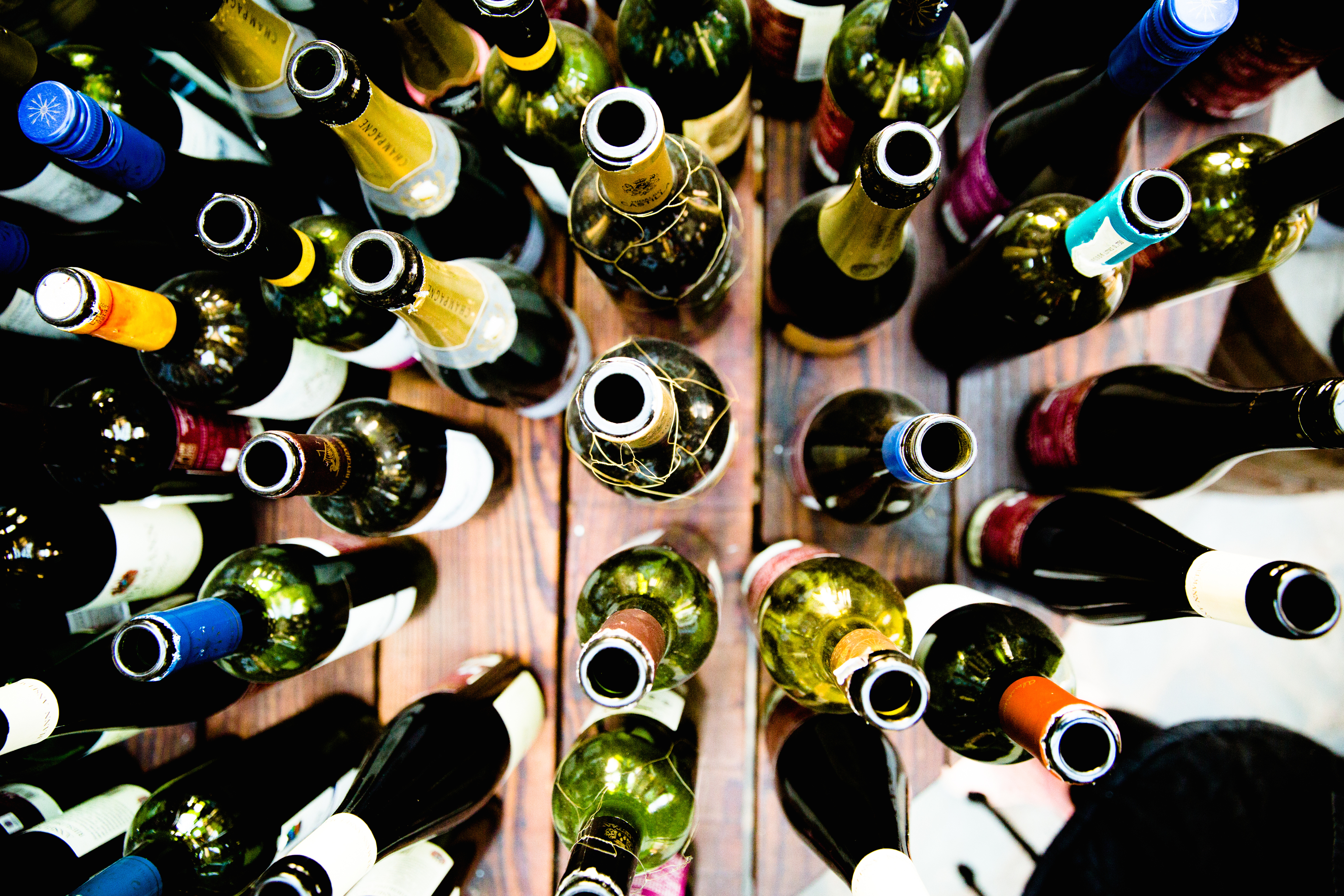 Various wine bottles arranged in a circle, viewed from above