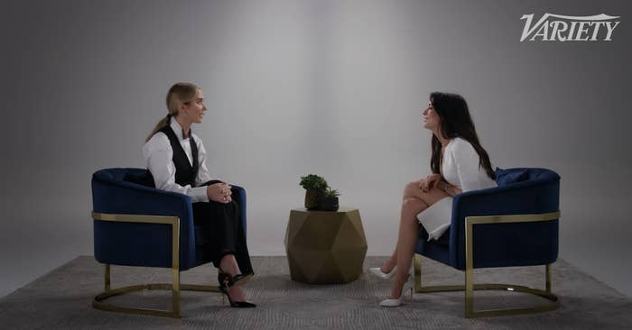 Emma Blunt and Anne Hathaway are seated and talking in an interview setting for Variety