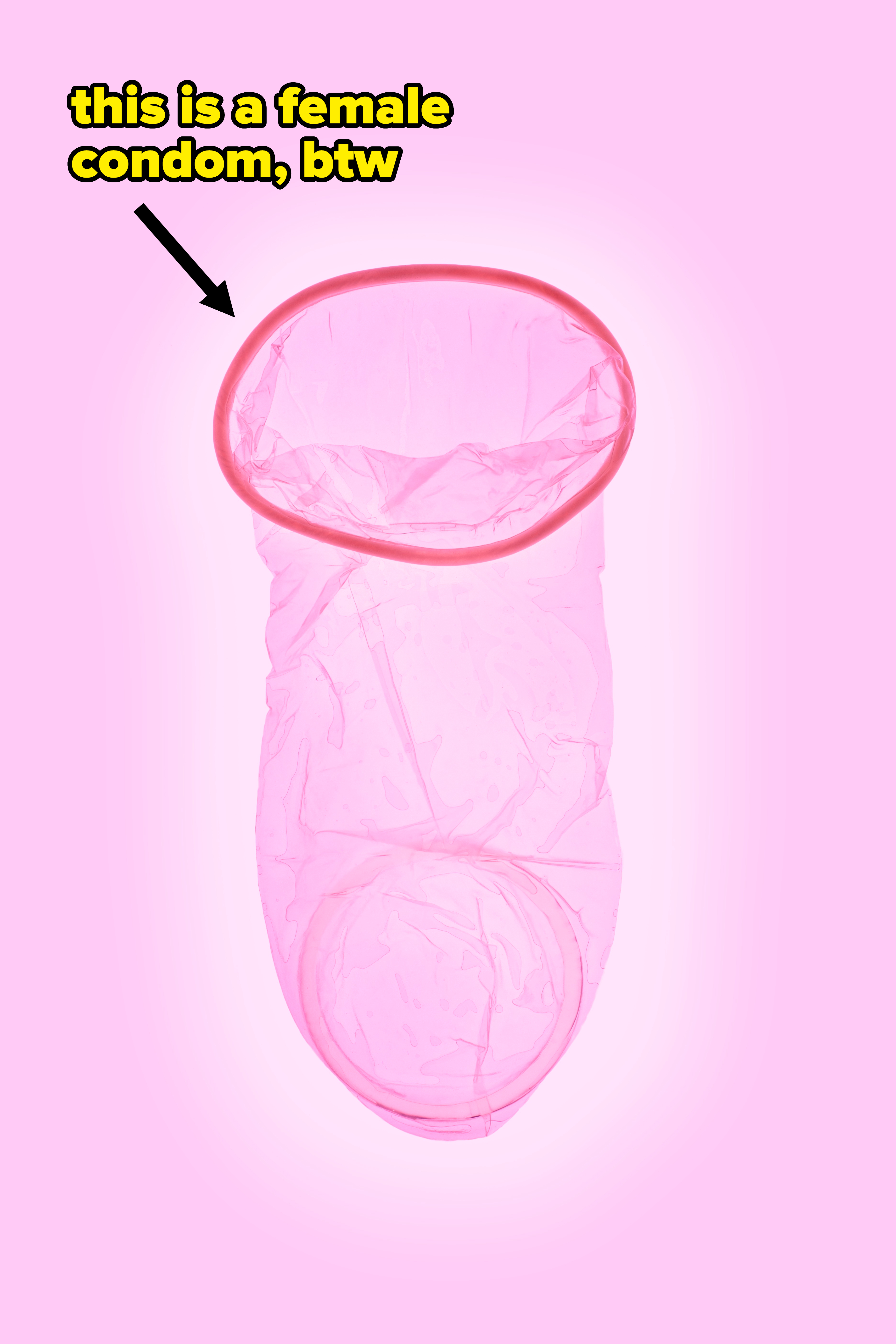 A female condom against a pink background