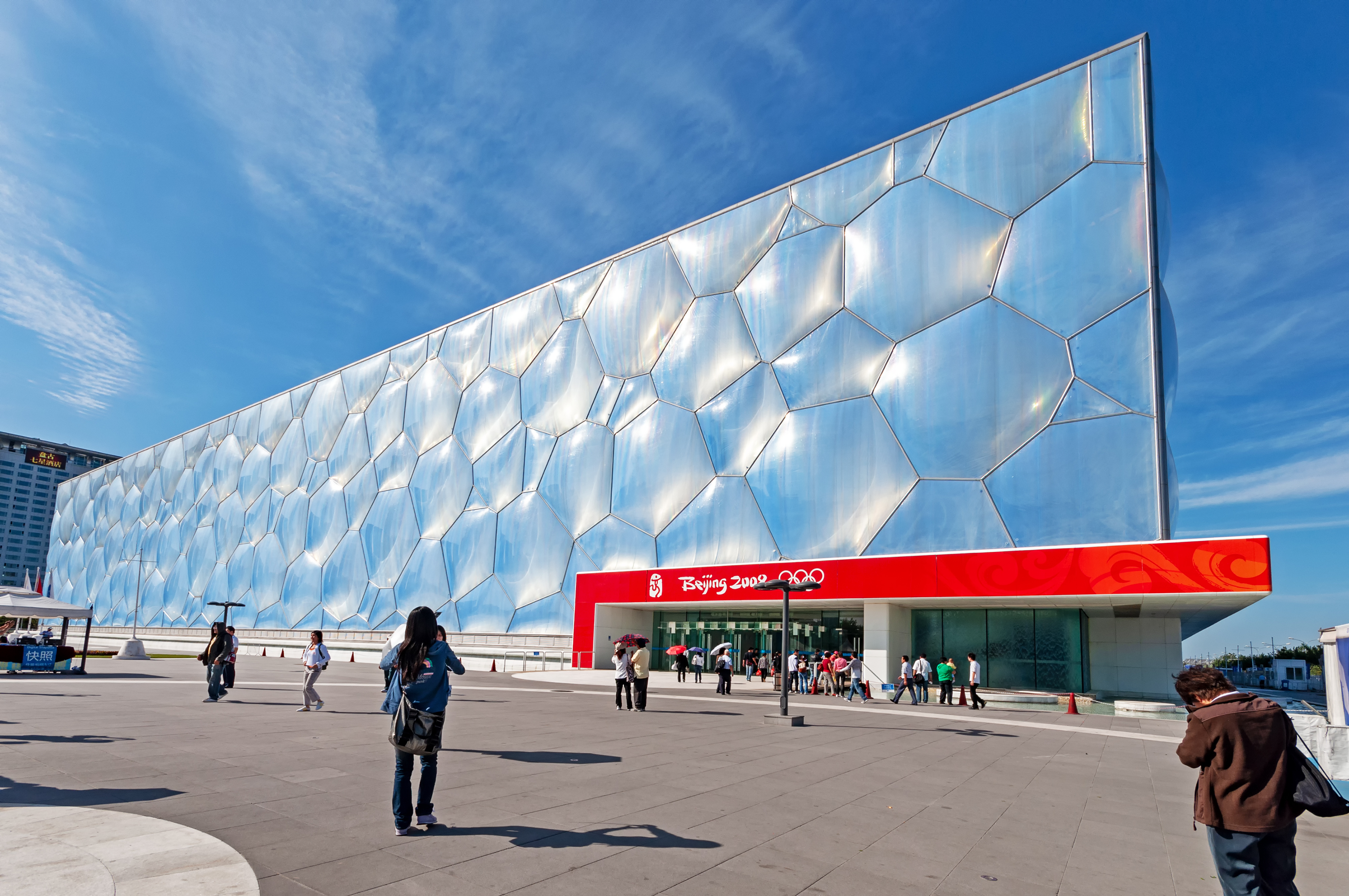 People walk outside the Beijing National Aquatics Center, also known as the Water Cube, a main venue for the 2008 Summer Olympics
