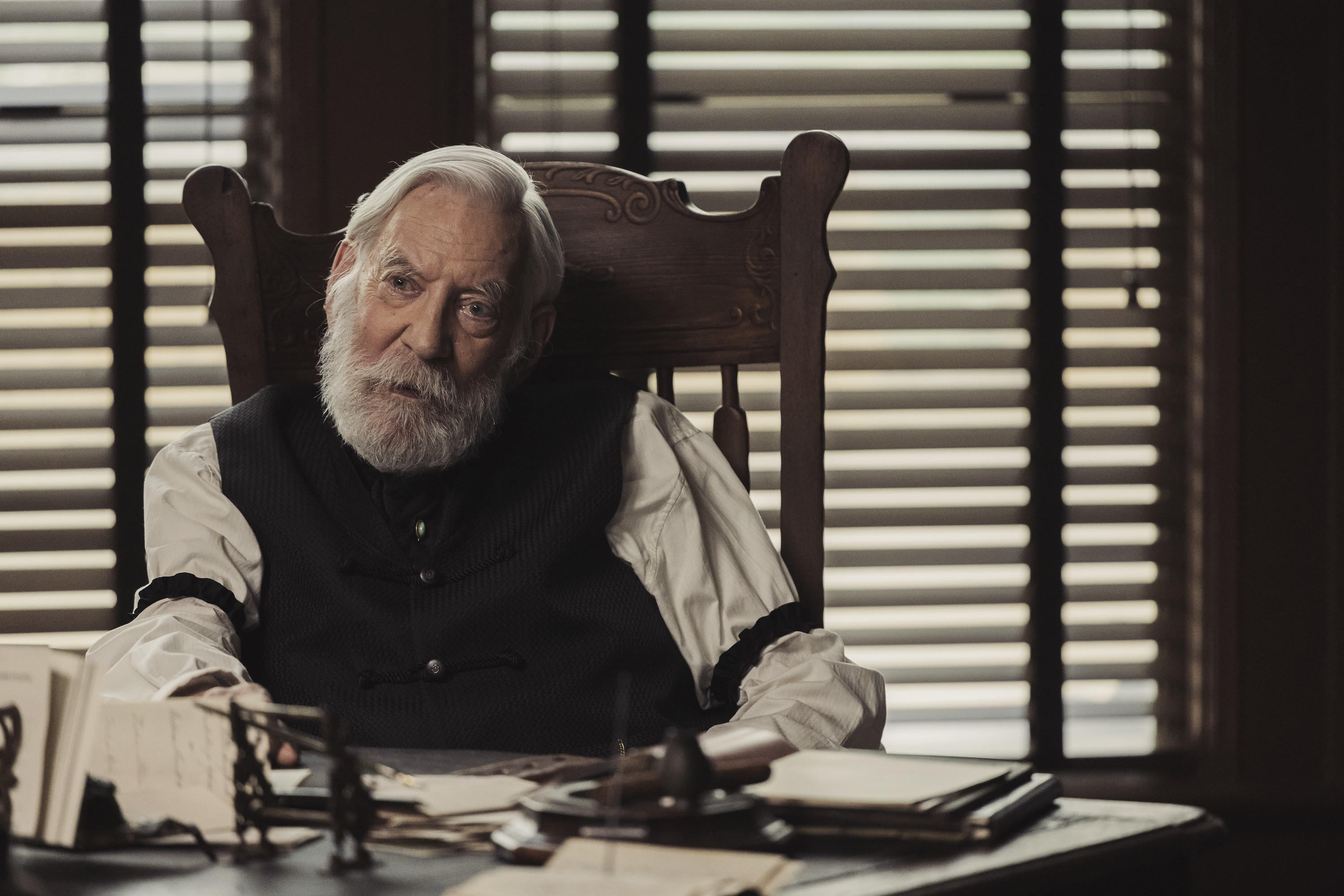 Closeup of Donald Sutherland sitting at a desk in a scene from "Lawmen: Bass Reeves"