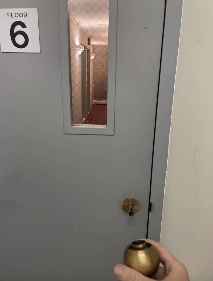 Hand opening door labeled "Floor 6" revealing a hallway inside
