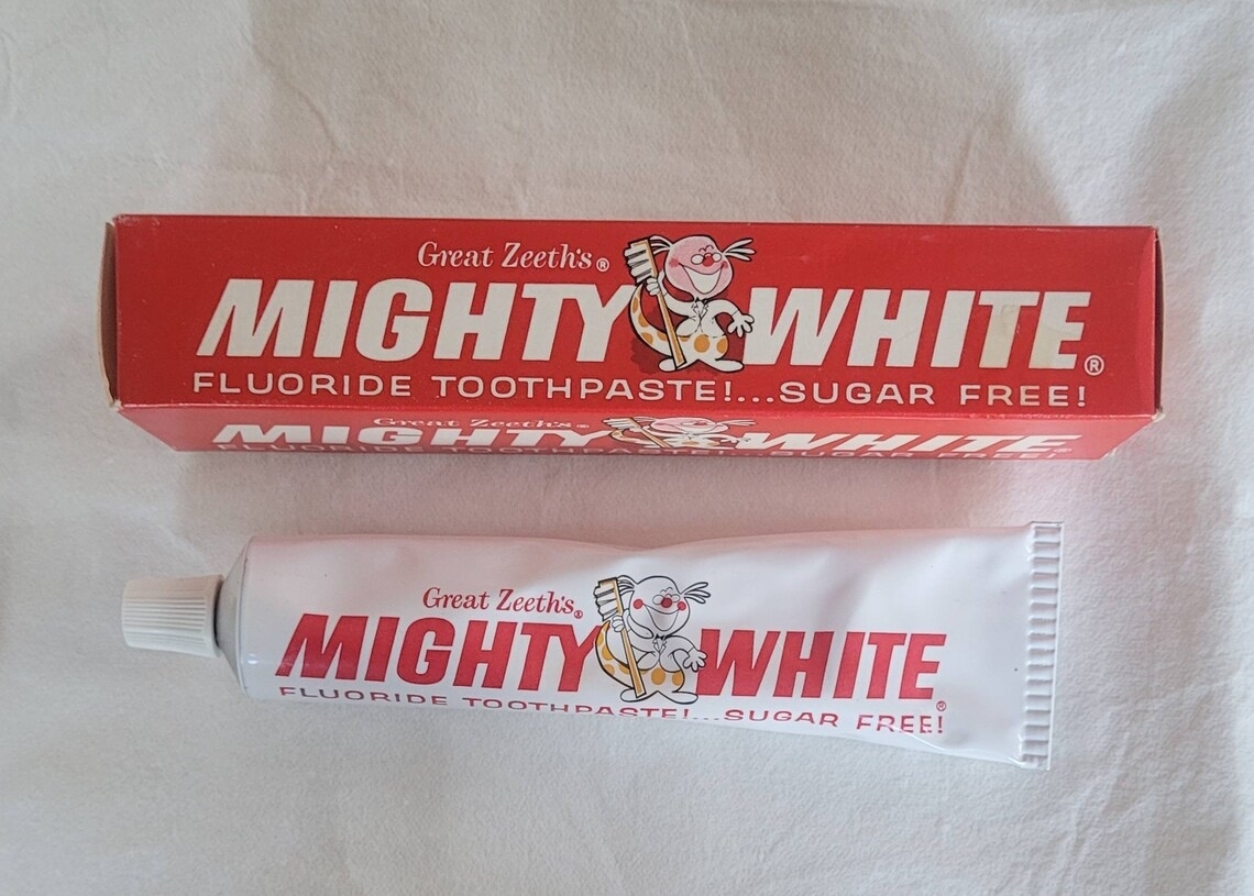 Mighty White fluoride toothpaste tube and box with the tagline "Great Teeth's Mighty White Fluoride Toothpaste!… Sugar Free!"