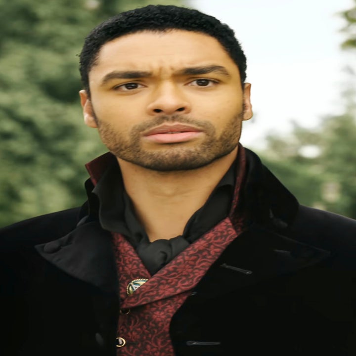 Regé-Jean Page as Simon Basset stands outdoors while wearing a high-collared coat and a patterned waistcoat