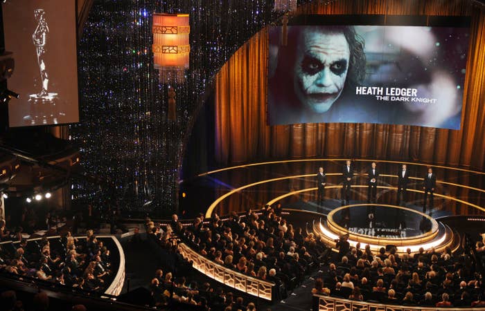 A ample  assemblage  is gathered astatine  an awards ceremony. On stage, a surface  displays an representation  of Heath Ledger arsenic  the Joker from &quot;The Dark Knight&quot; and his name