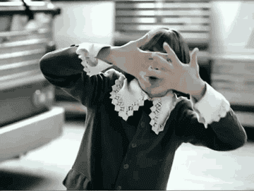 The Little Lad from the Starburst Commercial smiles and gestures with his hands
