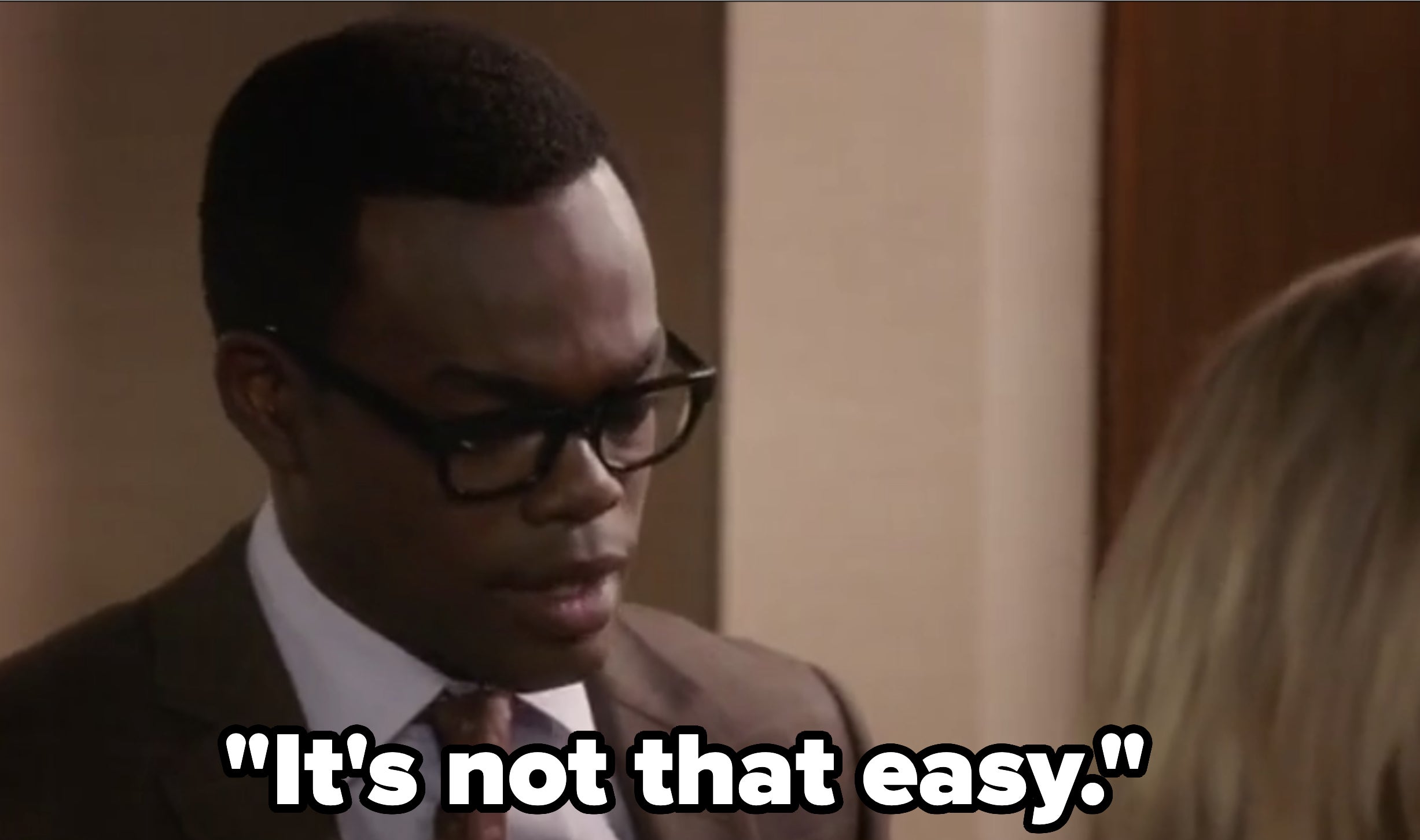 William Jackson Harper, wearing a suit and glasses, is in a scene from &quot;The Good Place&quot; with another unidentified person