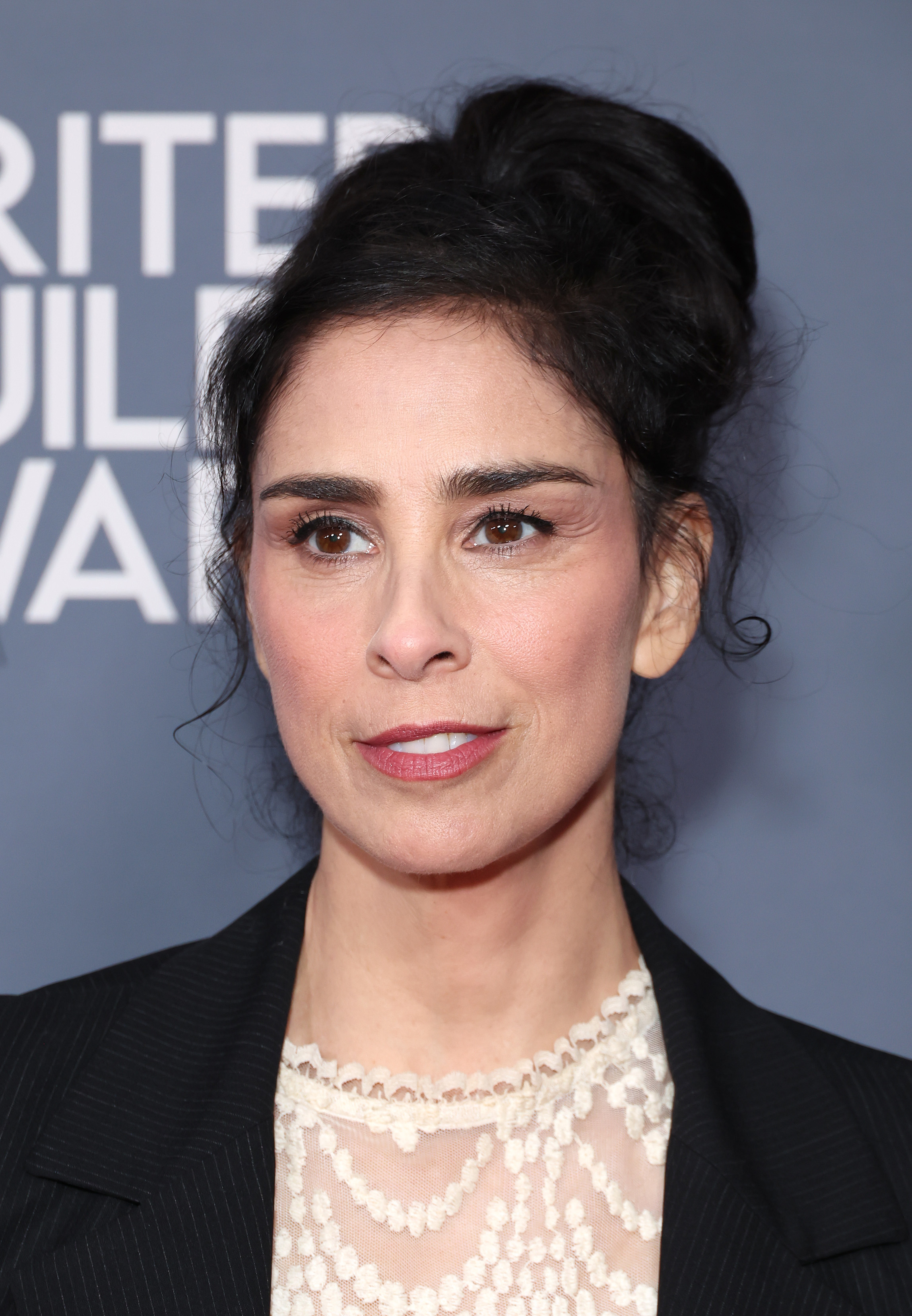 Sarah Silverman at Writer Guild Awards, wearing a black blazer over a lace-patterned top