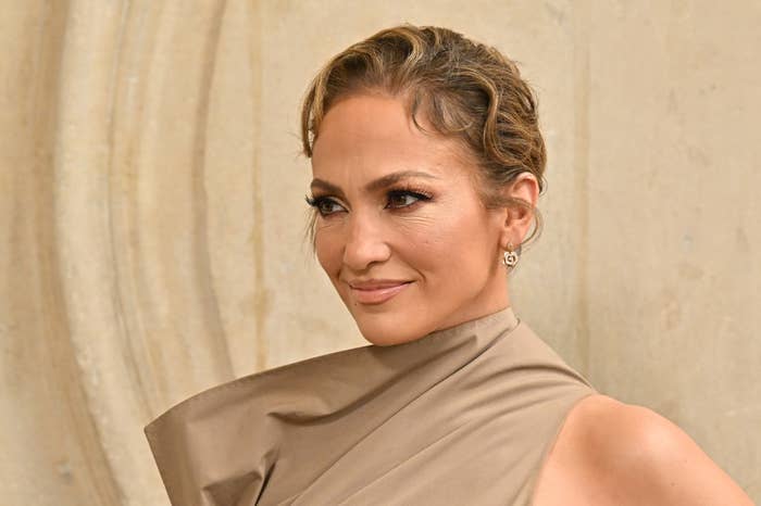 Jennifer Lopez poses in an elegant, high-neck, sleeveless dress