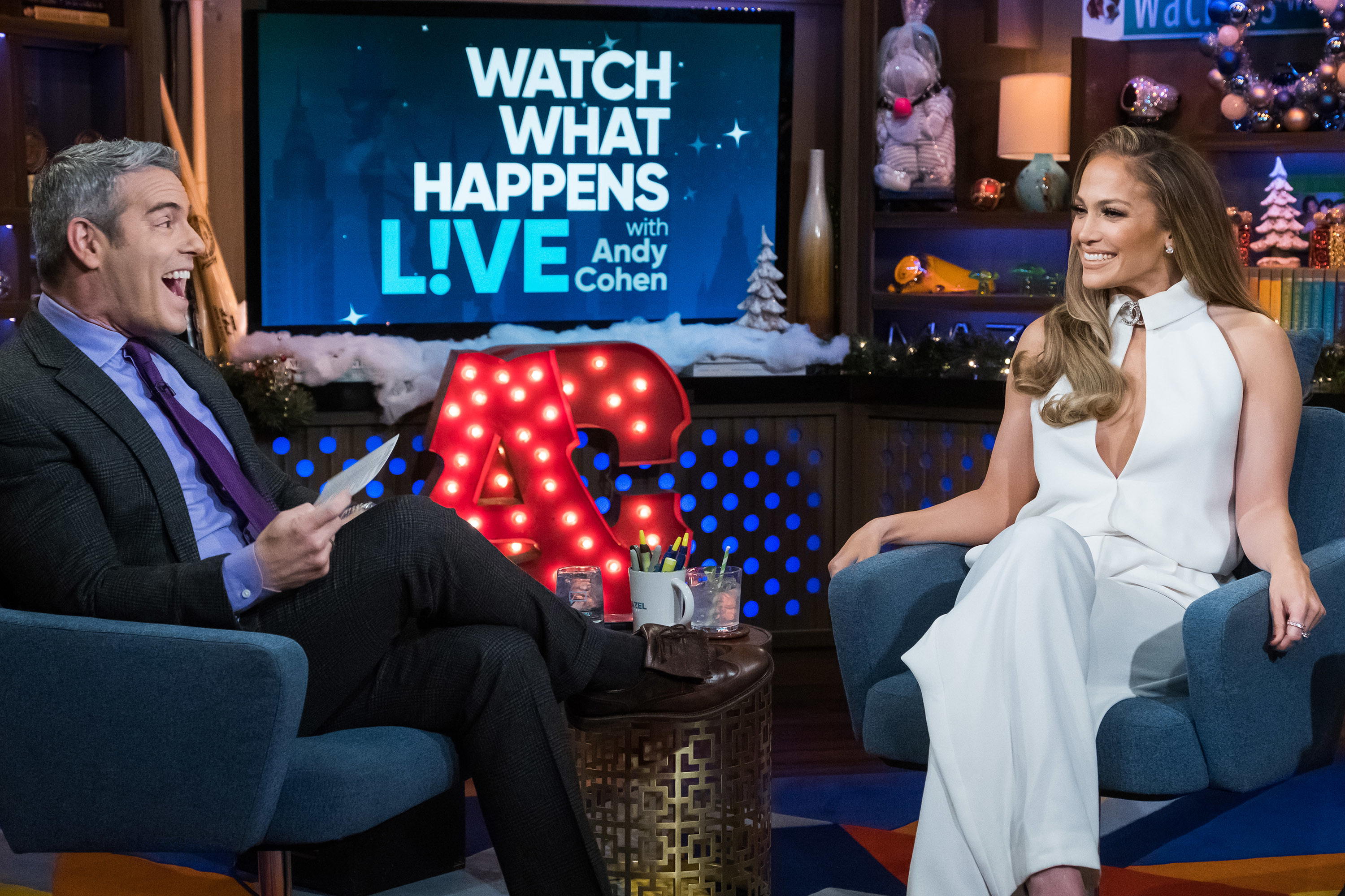Andy Cohen, seated, in conversation with Jennifer Lopez