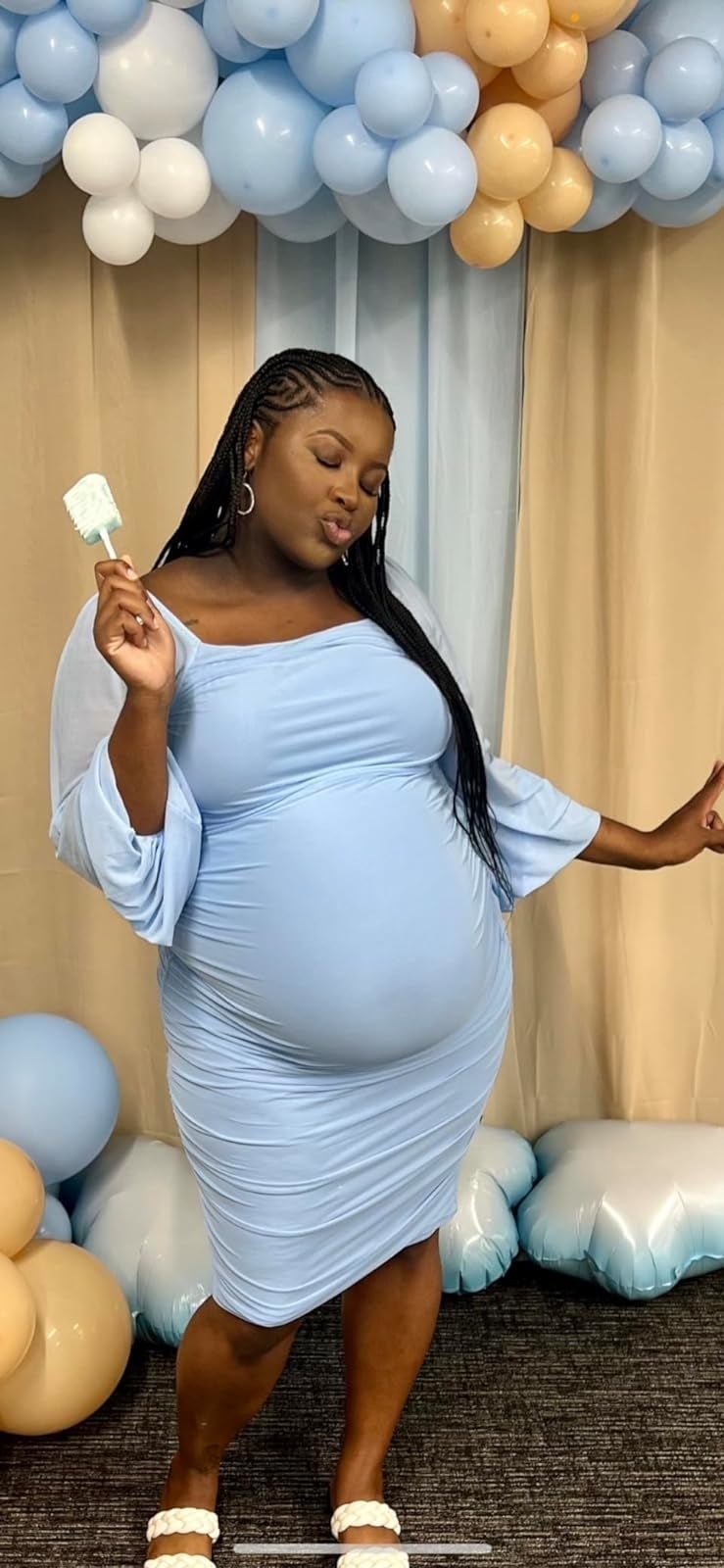 A pregnant reviewer wearing the dress