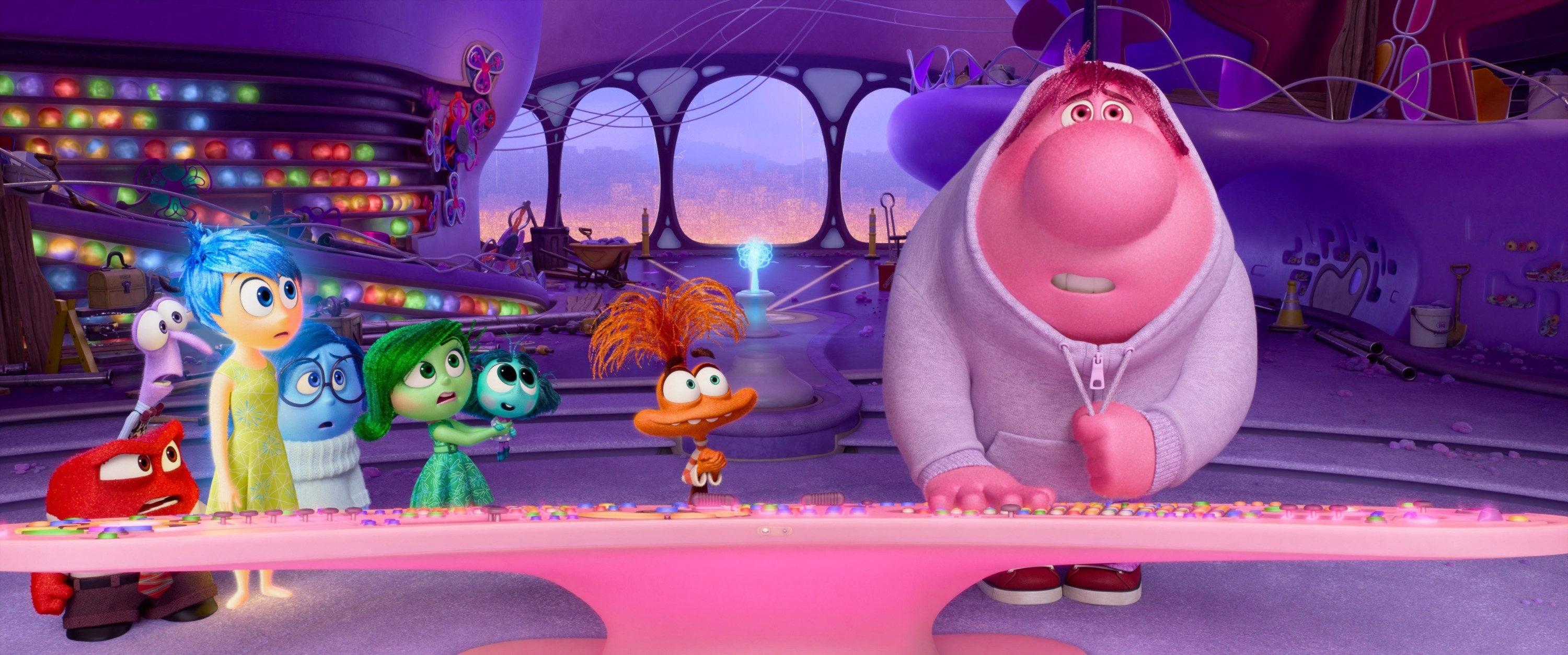 Characters from Inside Out (Anger, Joy, Fear, Disgust, Sadness, Bing Bong) stand in front of a control console in the mind's headquarters