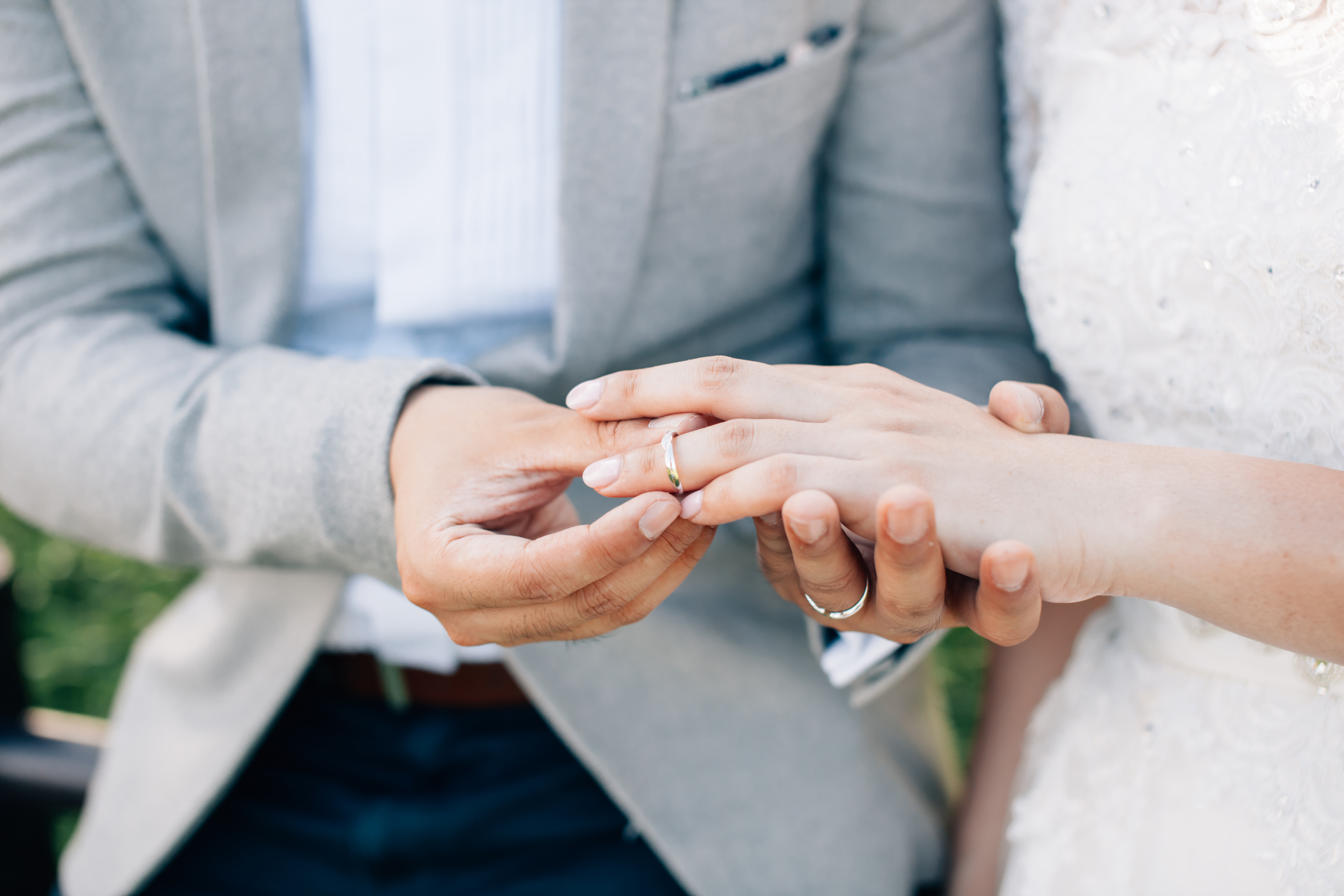 man putting wedding ring on a woman