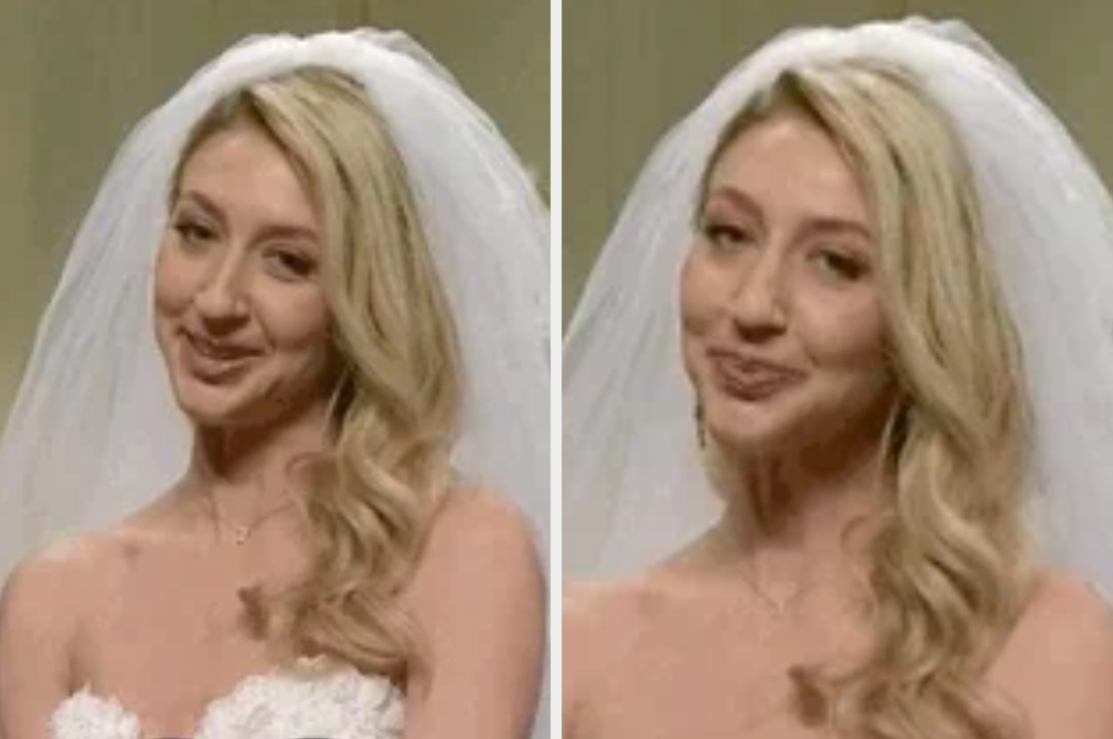 Bride in strapless wedding dress and veil, smiling with long, wavy hair