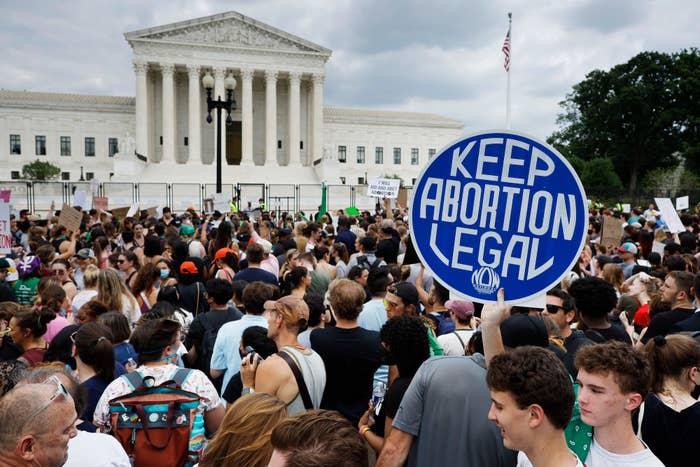 Protesters gather in front of the U.S. Supreme Court building. A sign in the crowd reads &quot;KEEP ABORTION LEGAL.&quot;