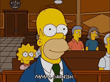 Homer Simpson in a courtroom, the text at the bottom says, &quot;MMM, GARNISH.&quot;
