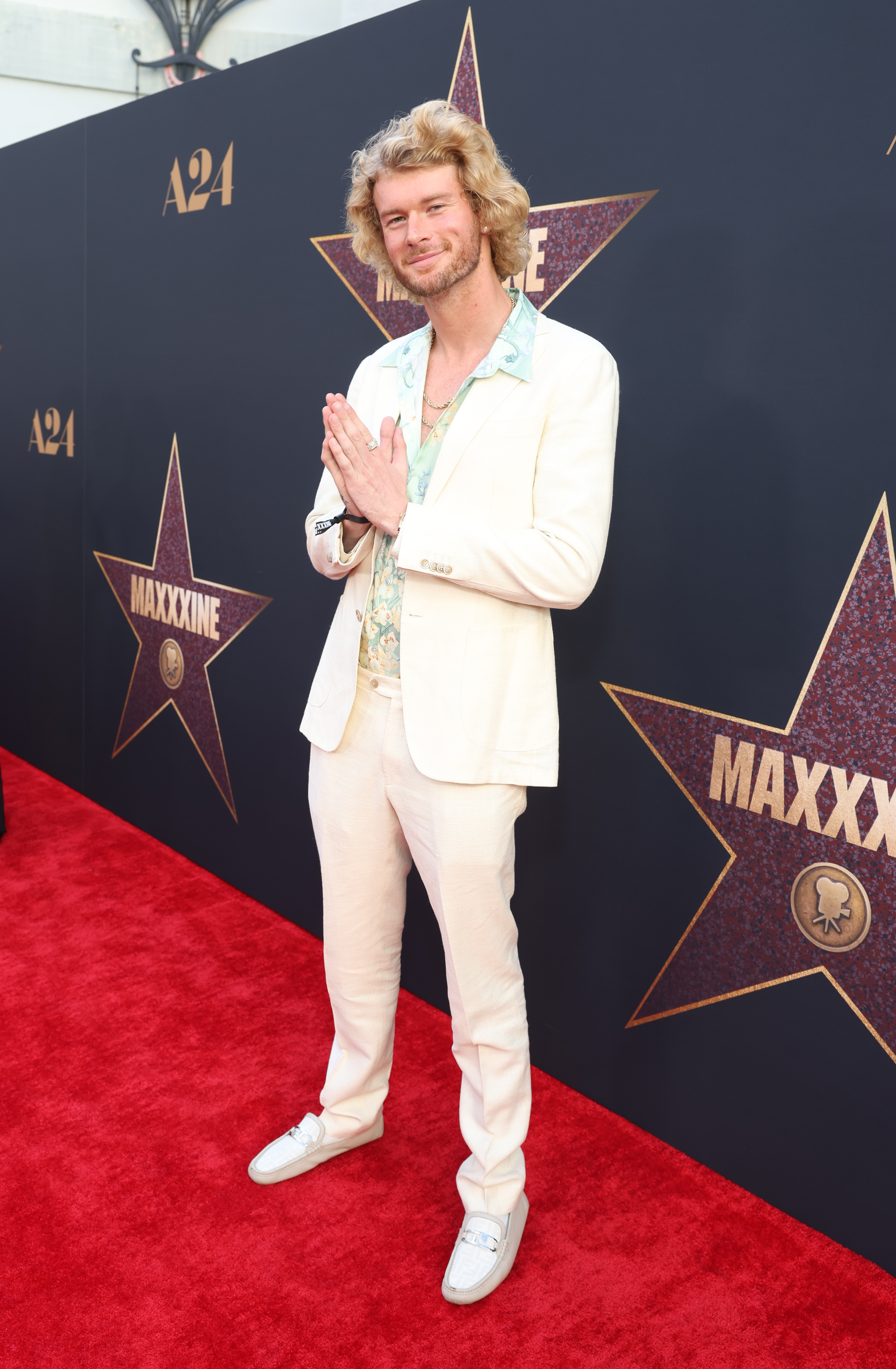 Yung Gravy on the red carpet in a light suit with a light-colored shirt